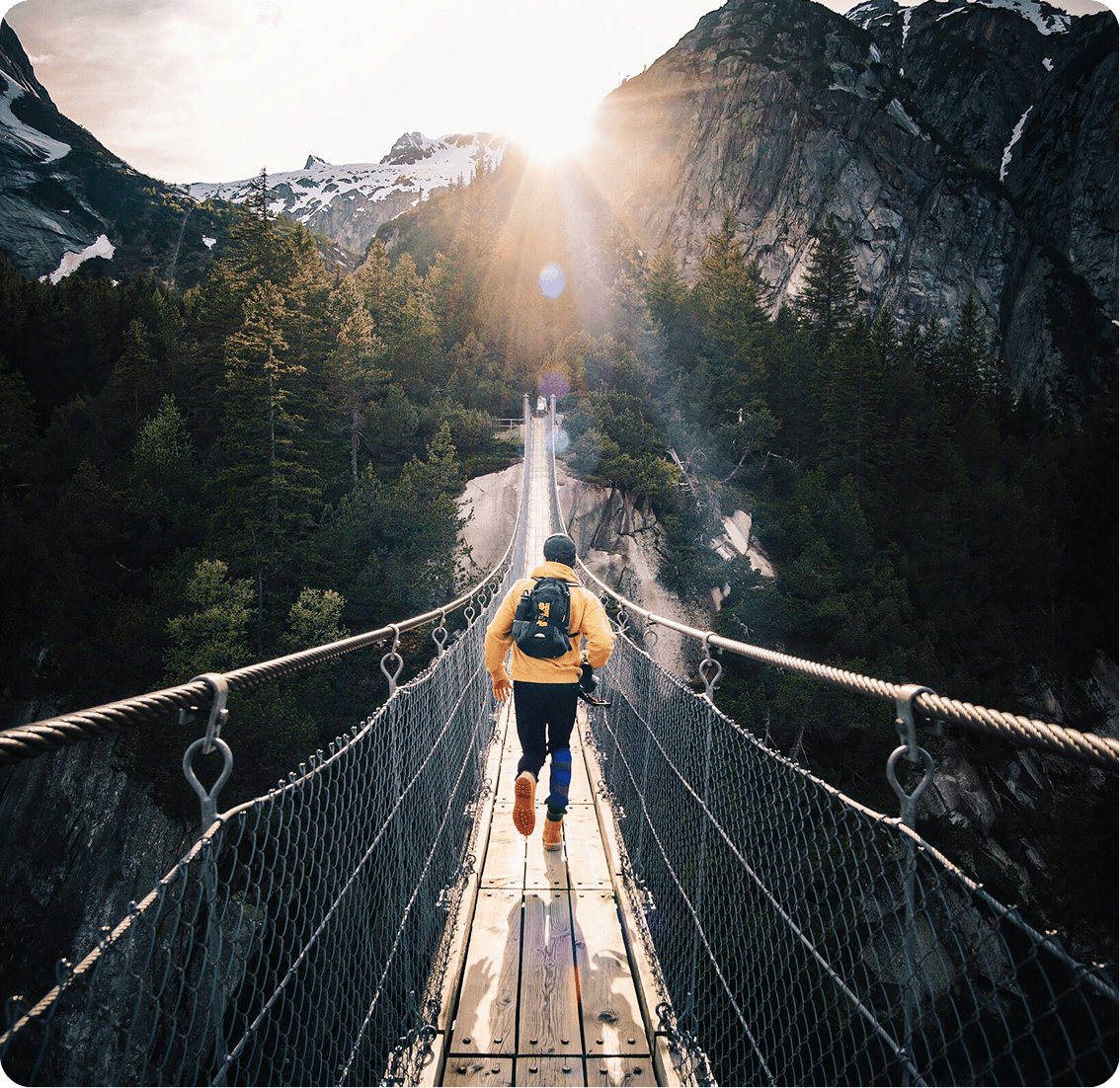 Hiking across a mountain bridge