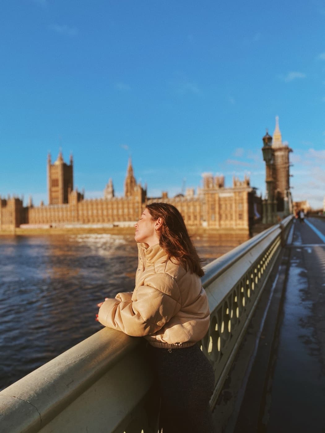 A woman pausing on Westminster Bridge in London